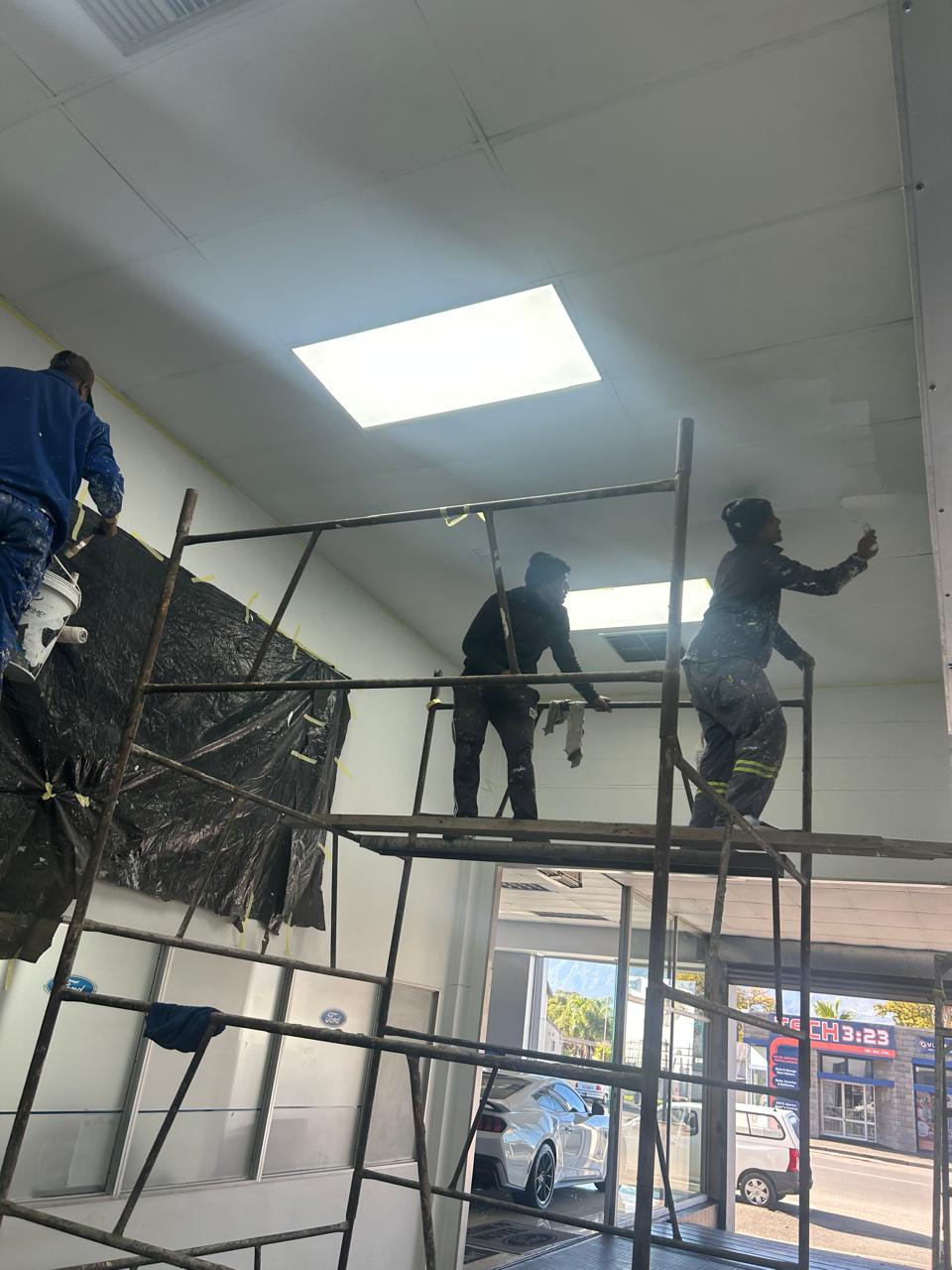 Painting crew on scaffolding